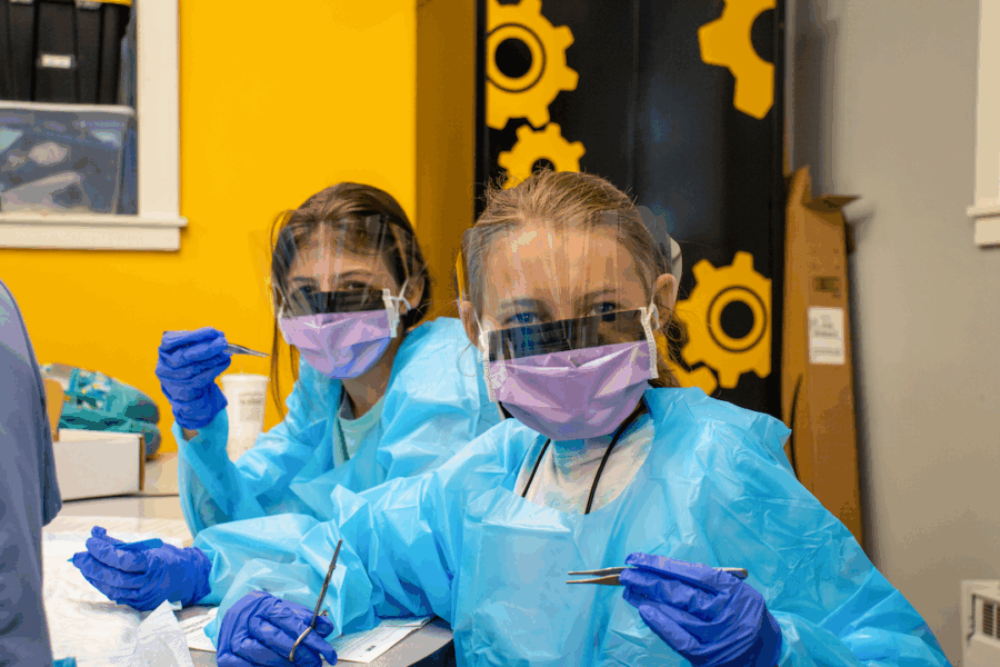 Two campers wear medical protection equipment.