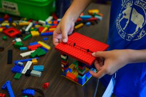 Student building lego structure