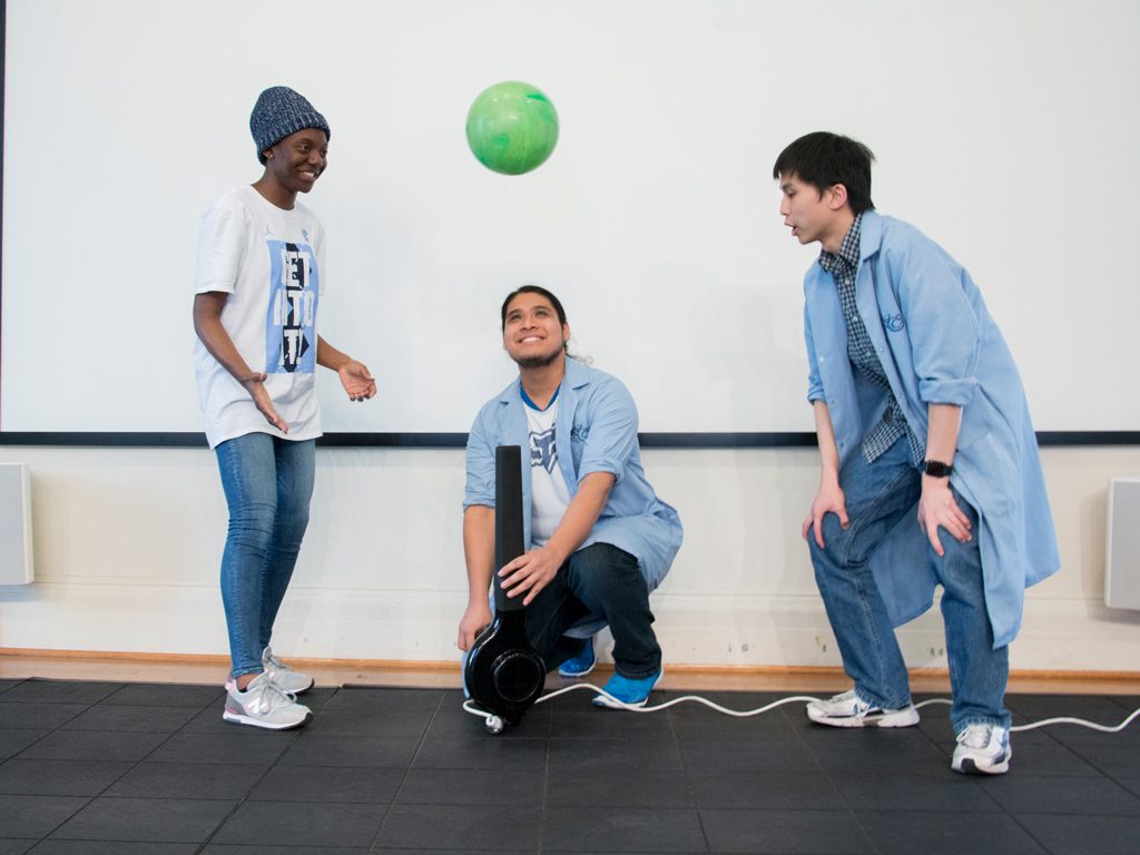 Student employees demonstrate Bernoulli's principle in Science Stage.