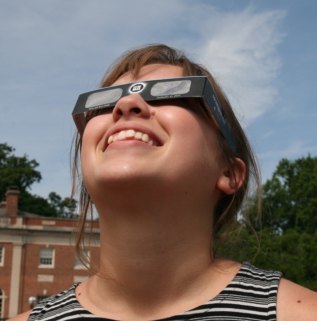 Woman wearing solar eclipse glasses