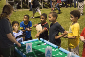 children playing table football game at tailgate