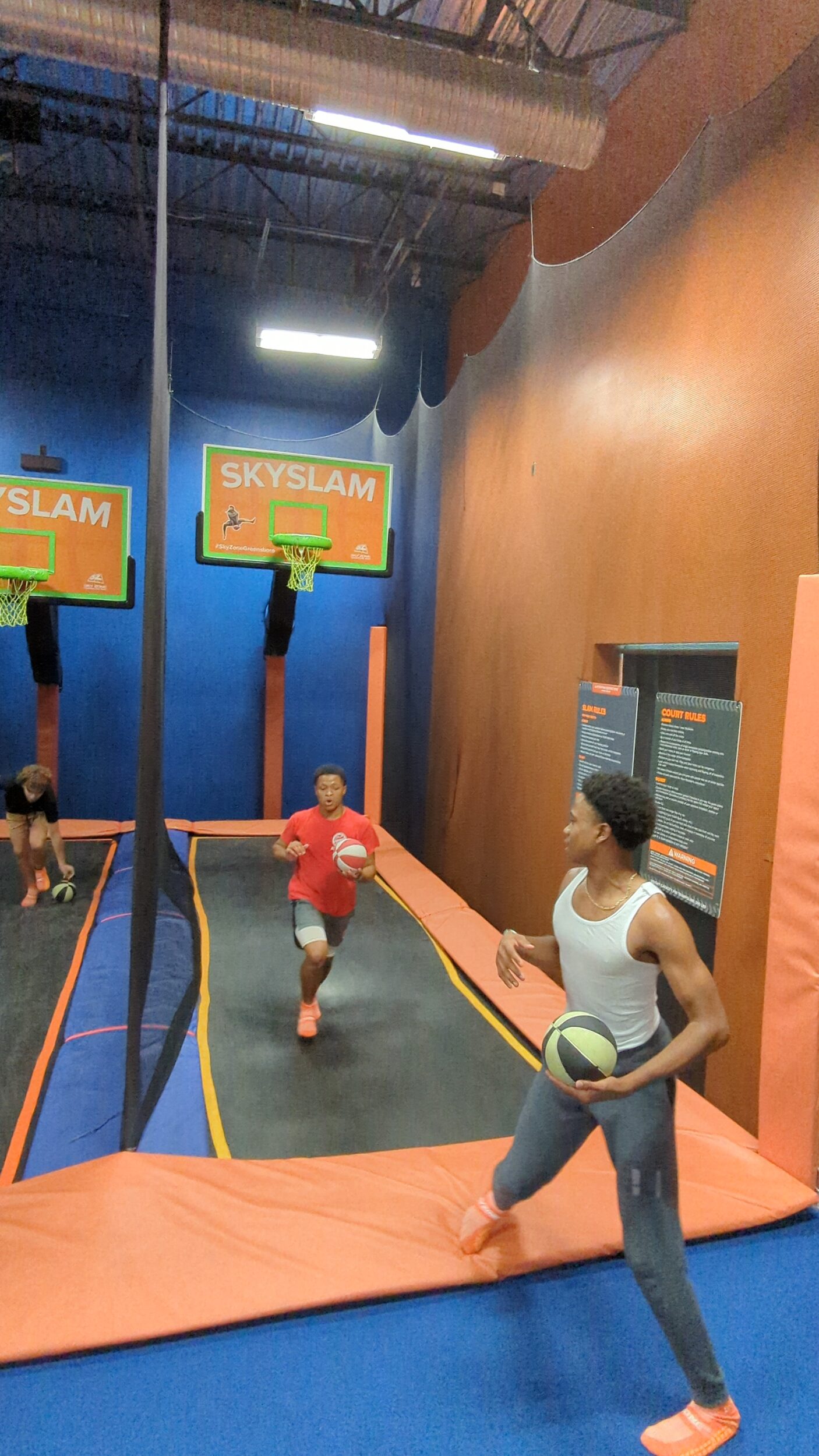 Students of Gates County play basketball at a trampoline park.