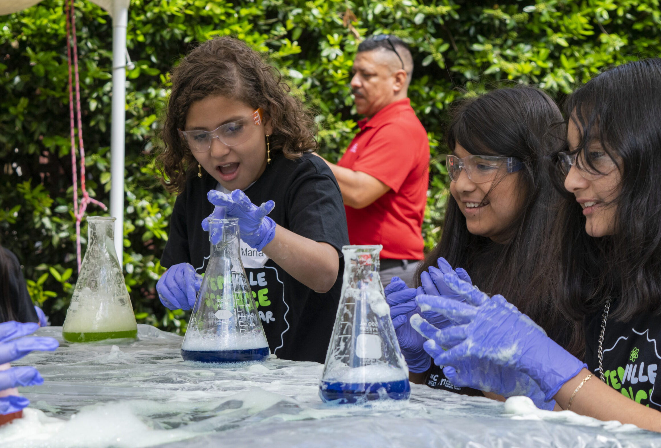 Children interacting with beakers.