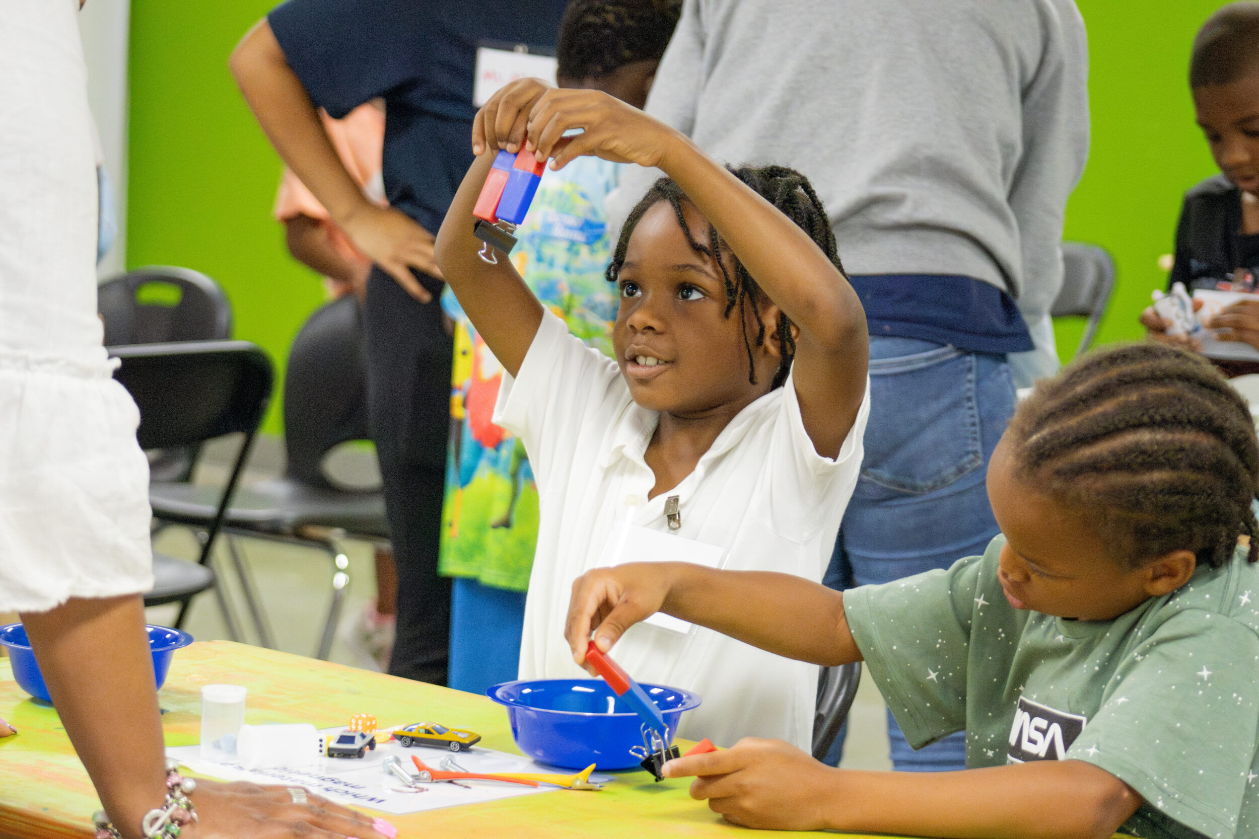Children participate in a Science in the Summer activity involving magnets.
