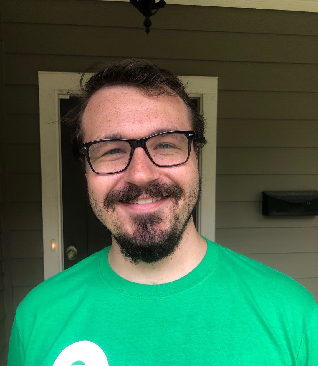 Solomon Starling wears a green shirt and smiles. 