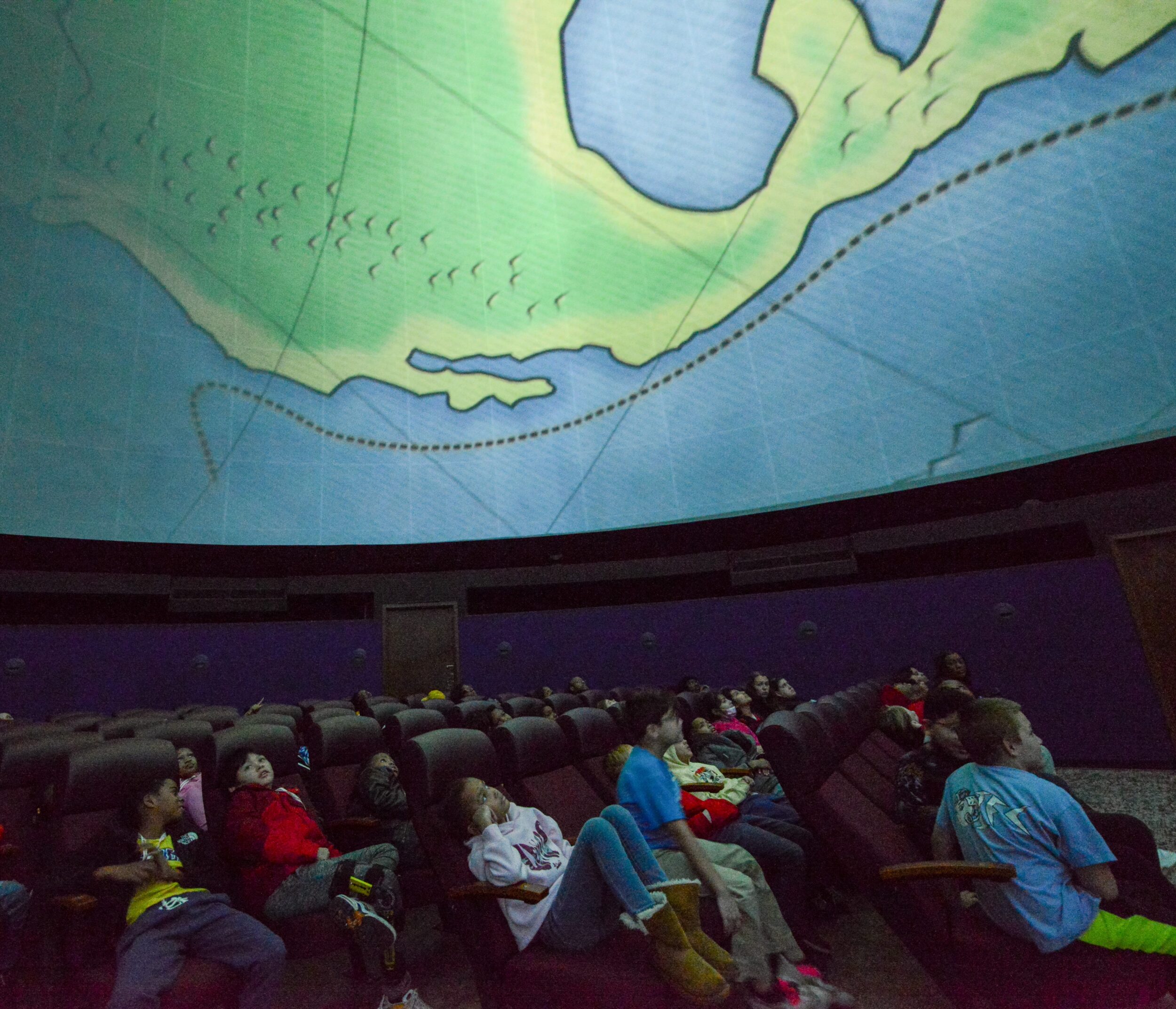 A school group watches a planetarium show at Morehead