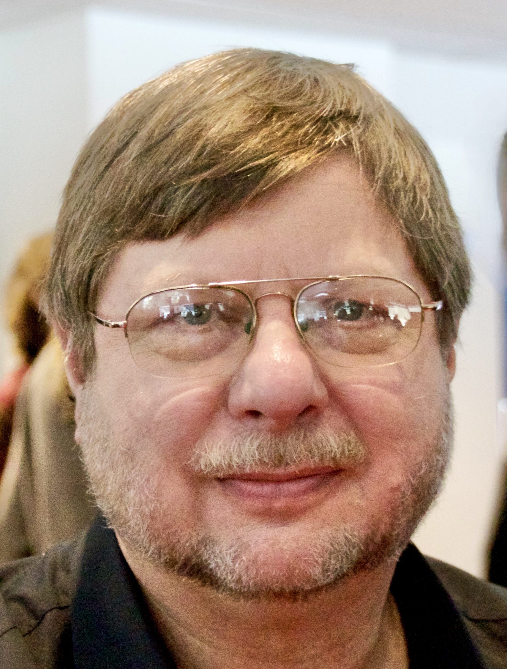 Dr. Brand Fortner wears glasses and a collared shirt.