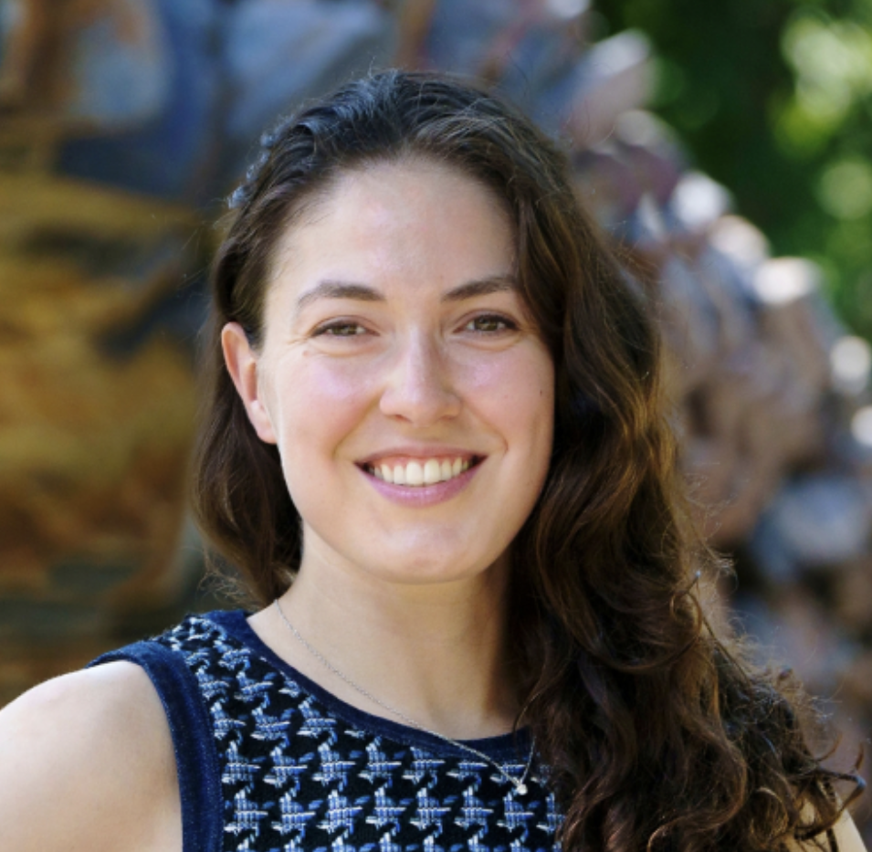 Dr. Eve Vavagiakis wears a patterned top and smiles.