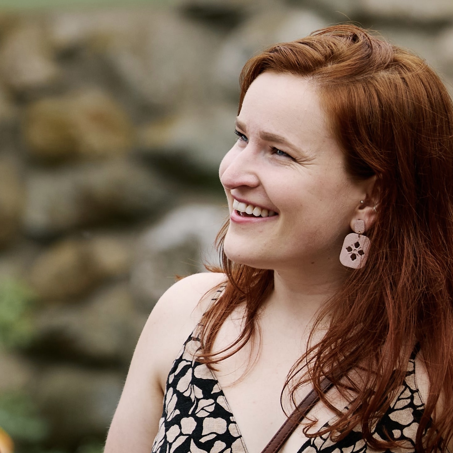 Dr. Katie Deaven smiles in a floral patterned shirt. She looks to the left.