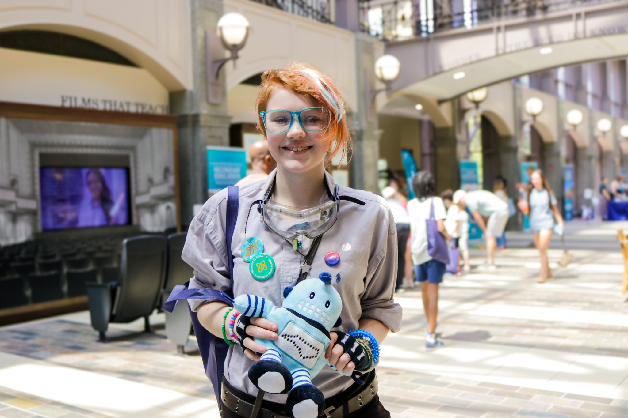 A child holds a plush version of Kelvin, the North Carolina Science Festival spokesbot.